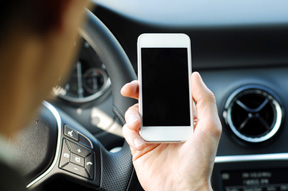 looking at phone while driving image on distracted driving accidents page for Heintz & Becker, a law firm in Sarasota and Bradenton florida
